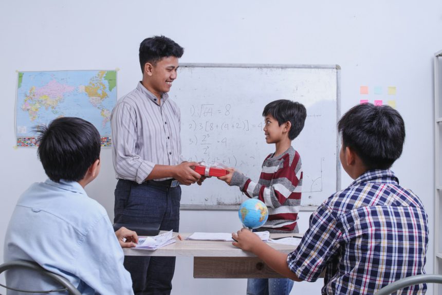 Teachers day, student presenting gift to teacher